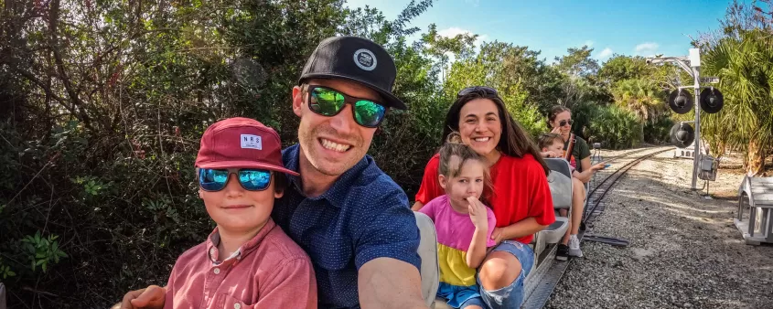 Family riding train at Lakes Park